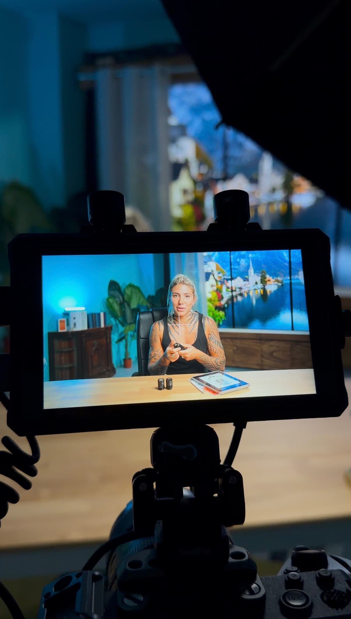Behind the scenes - Camera monitor view of presenter recording with Austrian village background on Infinite Digital Window